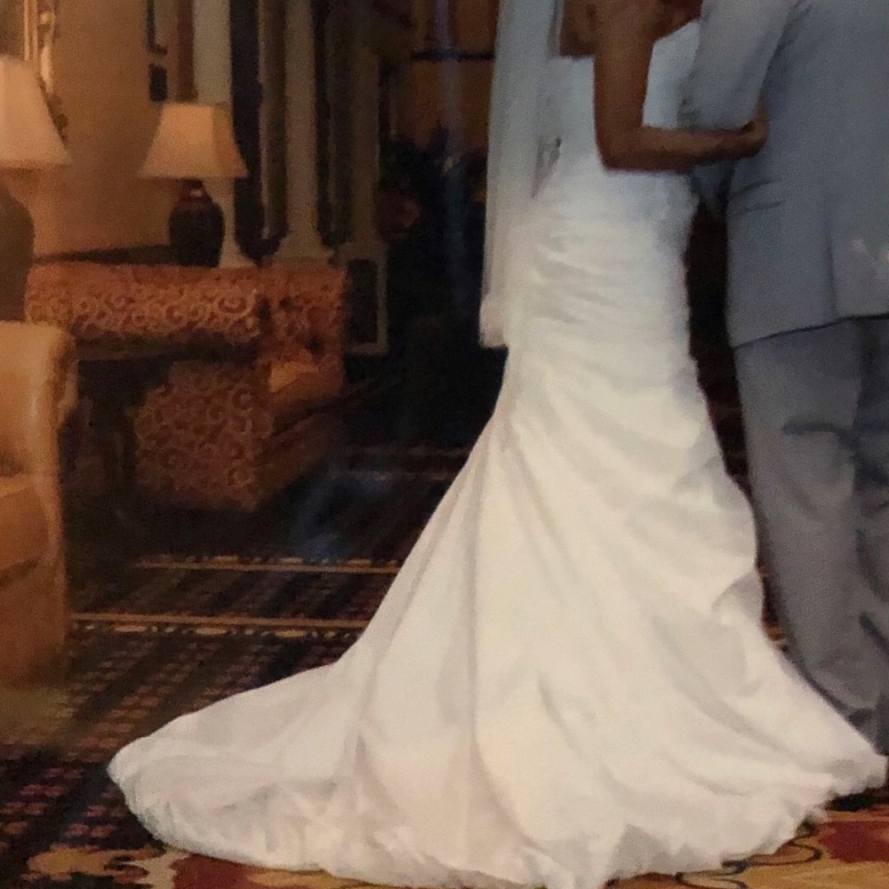 Fish tail white fitted wedding dress with rhinestone designs.